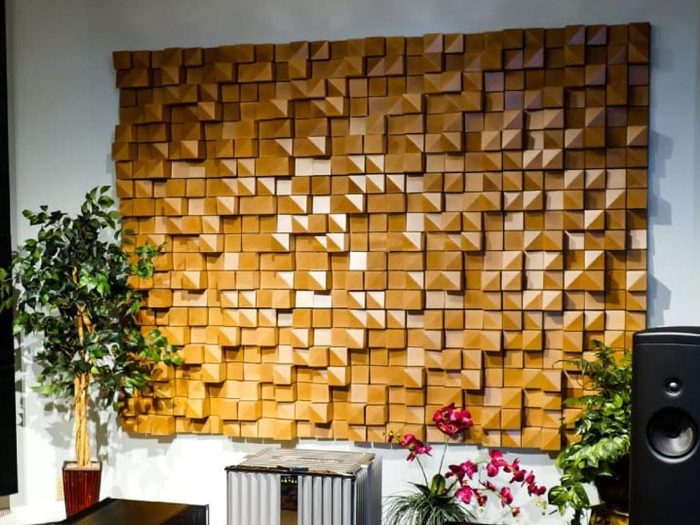 Piramit desenli ahşap akustik difüzör panellerle kaplanmış oturma alanı duvarı