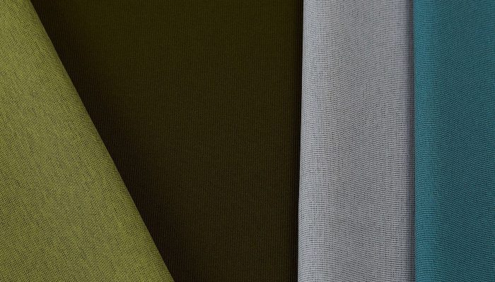 Camira Gravity kumaşının yeşil, haki, gri ve petrol tonlarında açılı renk kompozisyonu