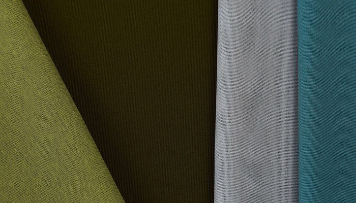Camira Gravity kumaşının yeşil, haki, gri ve petrol tonlarında açılı renk kompozisyonu