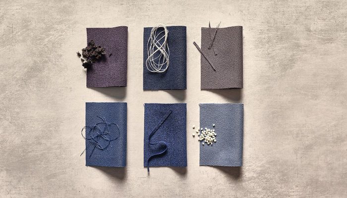 Camira Lucia T2T kumaşının mor, lacivert, gri ve mavi tonlardaki örnekleri, geri dönüşüm malzemeleri ve iplikle birlikte