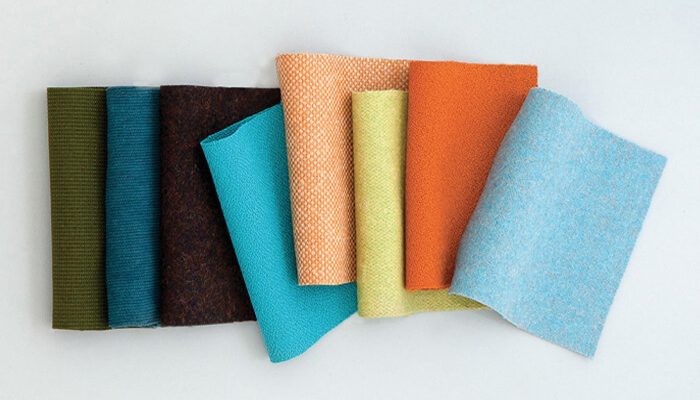 Camira Synergy 170 yün kumaşının yeşil, petrol, turuncu ve mavi tonlarında renk yelpazesi