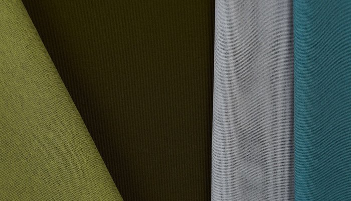 Camira Gravity kumaşının yeşil, haki, gri ve petrol tonlarında açılı renk kompozisyonu